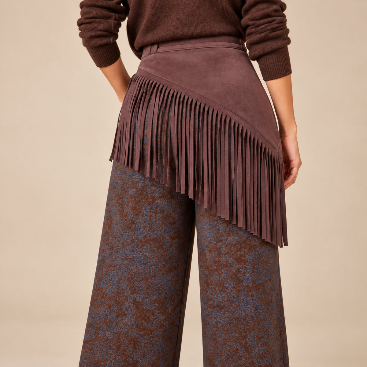 Dettaglio posteriore delle frange effetto scamosciato del pantalone Texas